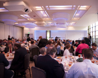 Summit attendees listening to Ayleen Robainas Barcia