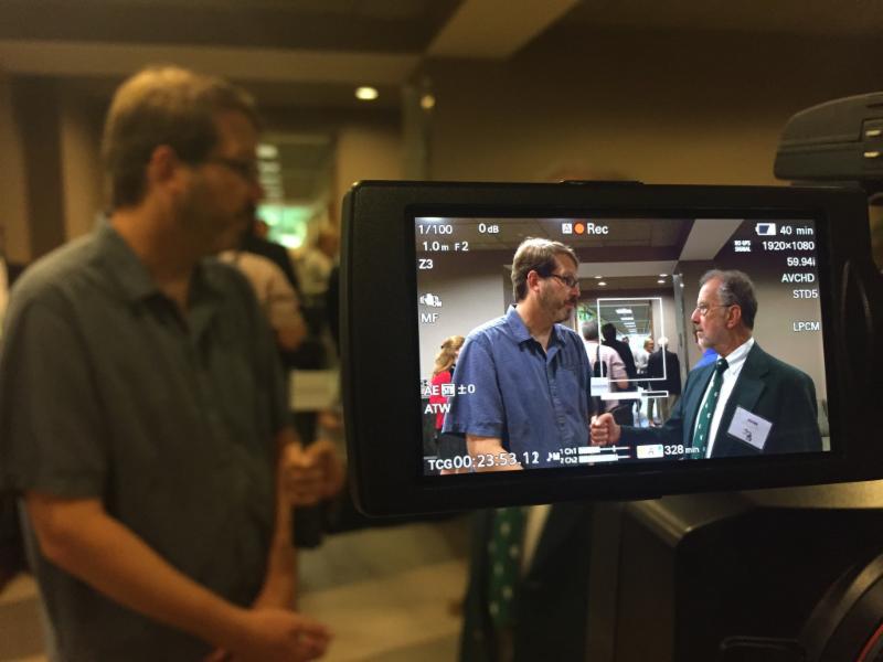 John Schweitzer interviewing summit  attendee